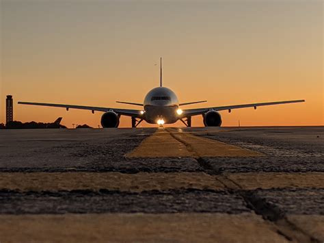 Boeing 777 departing runway during sunset international flight