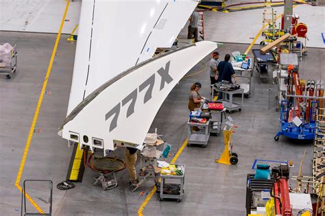 Boeing 777X undergoing wing flex stress test inside factory facility