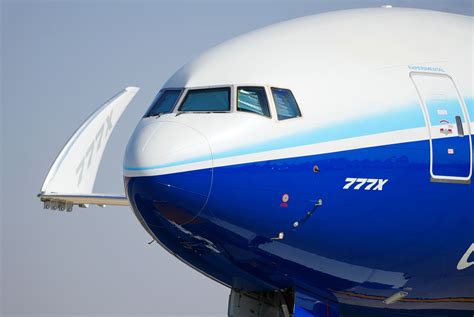 Boeing 777X wingtip hinge close-up showing composite structure and locking bolt