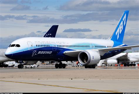boeing 787 aircraft in flight over a city skyline