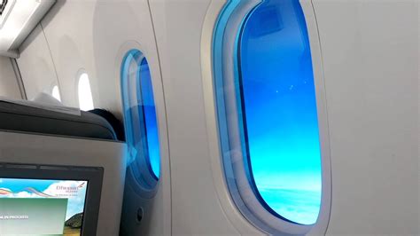 Boeing 787 electrochromic window dimming system glowing blue inside cabin