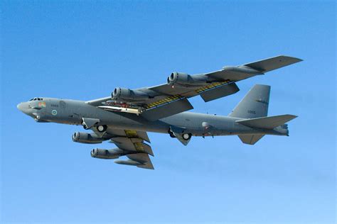 Boeing B-52 Stratofortress strategic bomber flying above desert landscape