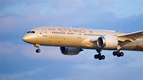 Boeing Dreamliner in final approach with vibrant sunset in background
