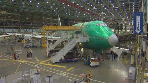 Boeing factory assembly line with aircraft under construction showing industrial scale production