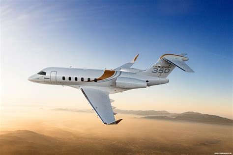 Bombardier Challenger 300 and Challenger 350 side by side on tarmac under sunset sky