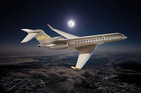 bombardier global 8000 on final approach over urban skyline during sunset