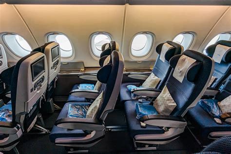british airways a380 economy class rows with blue seats and calm lighting
