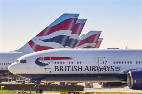 British Airways aircraft lineup at London Heathrow airport terminal with multiple BA jets parked