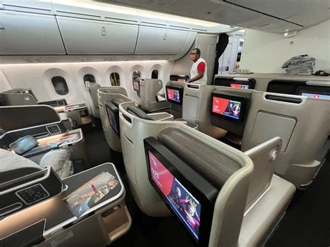 british airways boeing 787-9 seat with passenger using laptop for entertainment
