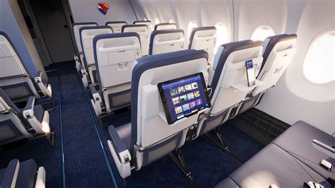 British Airways cabin showing both seatback screens and personal devices in use