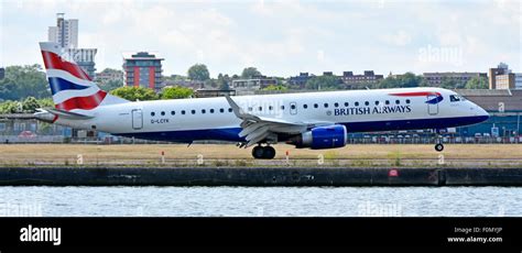 British Airways Embraer E190 landing at London City Airport with Canary Wharf skyline