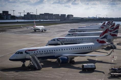 British Airways steward escorting passengers post-flight at Heathrow