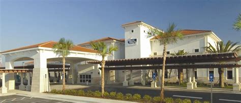 Brunswick Golden Isles Airport entrance with palm-lined roadway and small terminal building