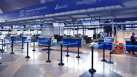 Brussels Airlines check-in counter featuring EU travel rights posters