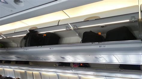 budget airline cabin with minimal legroom and overhead baggage