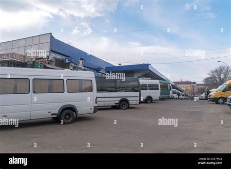 bus station outside chișinău airport terminal with travelers boarding public transport