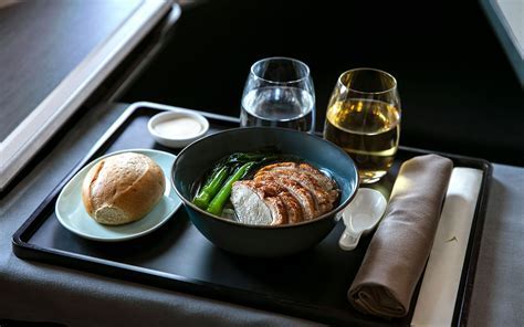 Business class in-flight meal served on SAA flight with South African wine