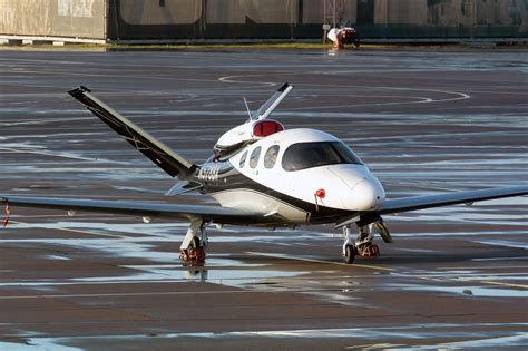 Business passengers boarding a Cirrus Vision Jet under fractional program