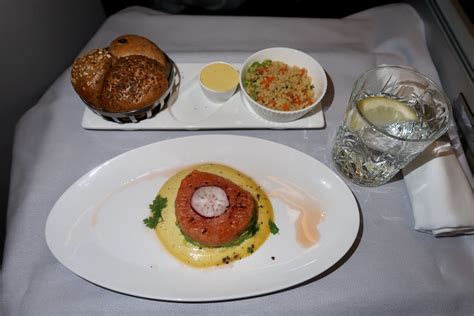 Business traveler enjoying gourmet meal in British Airways Club Suite