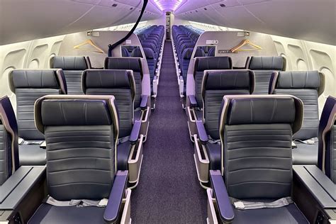 business traveler working in premium economy seat