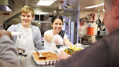 busy fast-food kitchen during lunch rush with multitasking crew