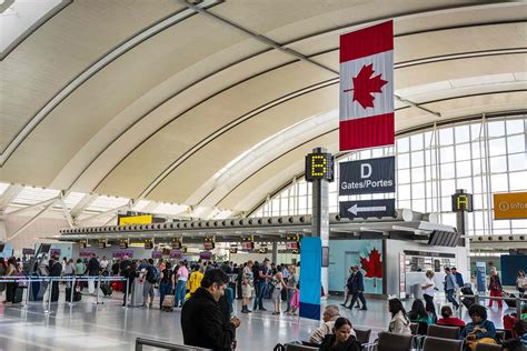 busy international arrivals terminal at Toronto Pearson Airport