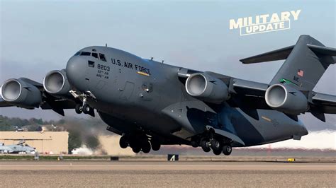 C-17 Globemaster III tactical landing with defensive sensors visible on fuselage