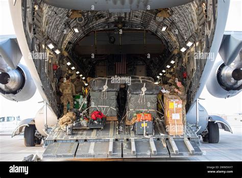 C-17 Globemaster III unloading humanitarian aid pallets after earthquake
