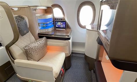 cabin crew demonstrating features of new high-back economy seat on emirates a350