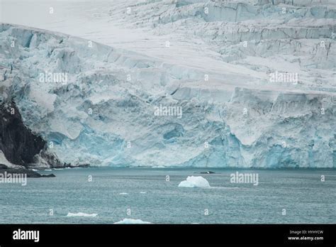 calving glacier at King George Island with expedition group watching from safe distance