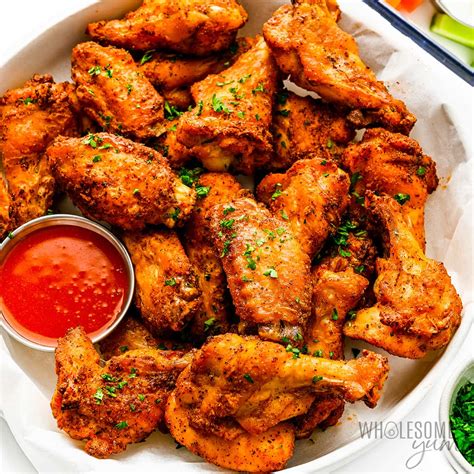 Cameo Pizza crispy chicken wings with spicy BBQ sauce next to a pepperoni pizza