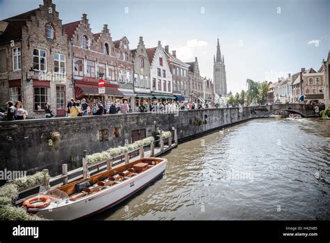 canal view in Bruges with stone bridges and medieval facades