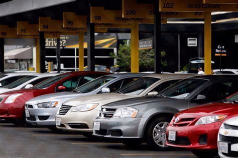 car rental lot with prices slashed banners in April 2025 recovery market