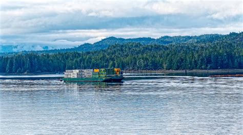 cargo barge transporting freight containers along Alaska coastal waters