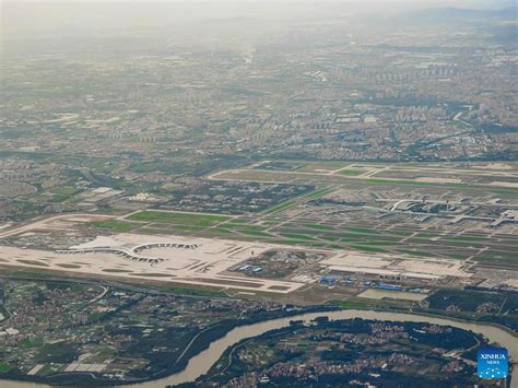 cargo terminal at Guangzhou Baiyun International Airport with trucks and aircraft in motion