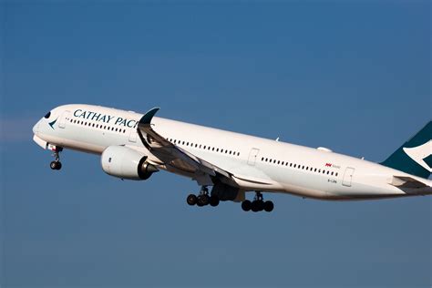 Cathay Pacific Airbus A350 cockpit and wing view over Hong Kong skyline