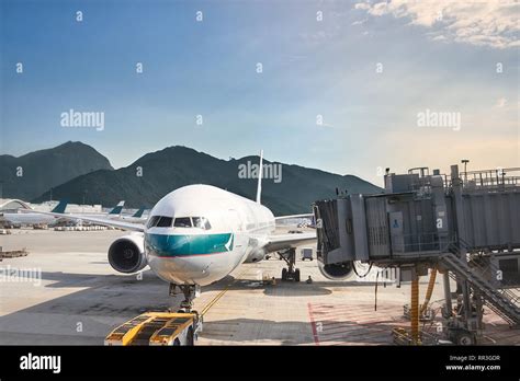 cathay pacific aircraft departing hong kong at sunrise