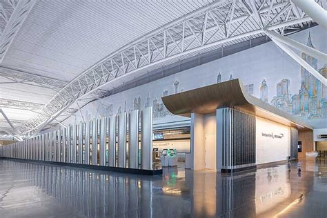 Cathay Pacific and American Airlines jets at adjacent gates at JFK Airport