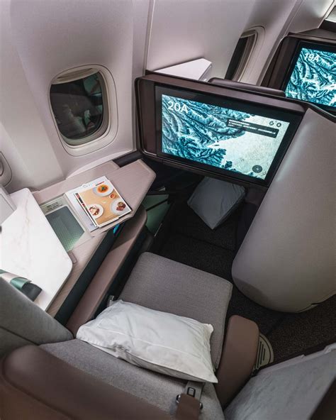 Cathay Pacific Aria Suite business class seat with sliding door and 4K entertainment screen