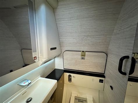 Cathay Pacific Aria Suite business class seat with wide screen and privacy door