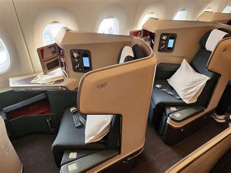 Cathay Pacific business class seat with passenger relaxing