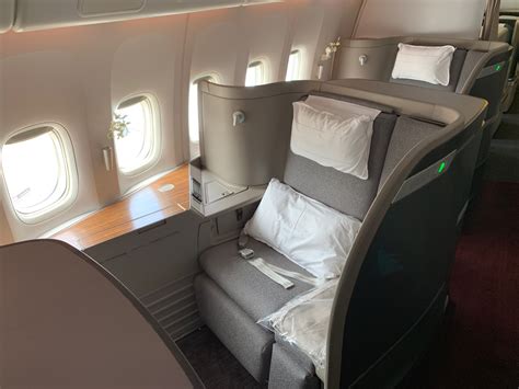 Cathay Pacific First Class suite interior with wide seat and amenities