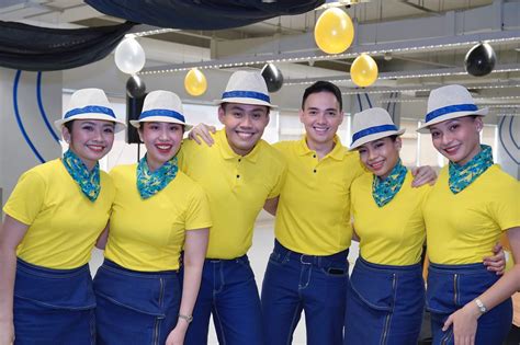 Cebu Pacific cabin crew assisting passengers during a flight
