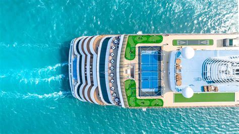 Central Coast beach aerial view with docked cruise tender boats and day-tour buses