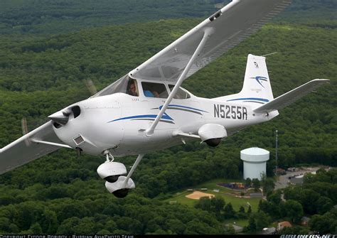 Cessna 172 Skyhawk flying above forest landscape
