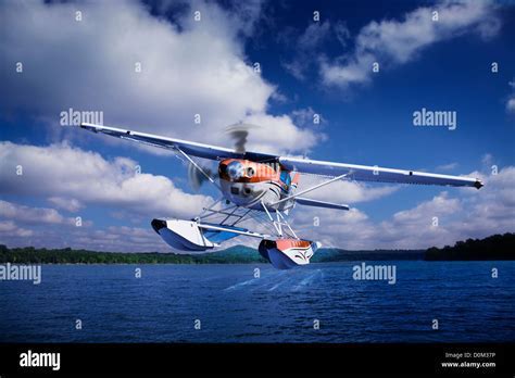 cessna 206 with floats taking off from remote lake