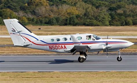 cessna 414 chancellor in flight over mountainous terrain