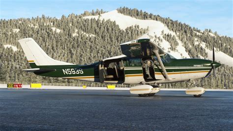 cessna t206h stationair in flight over mountainous terrain