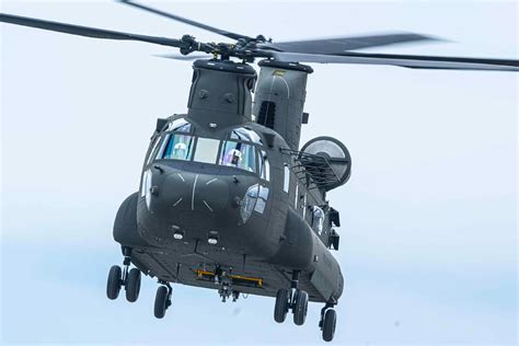 CH-47F Chinook flying low over mountainous terrain during tactical mission