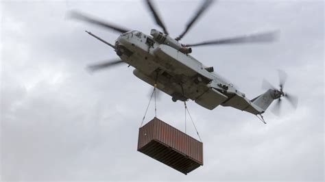 CH-53K King Stallion and CH-47 Chinook flying in formation over ocean
